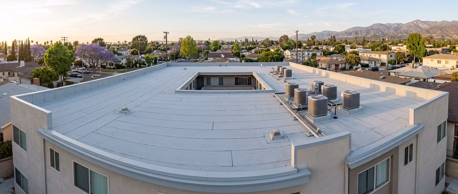 Reflective cool roof membrane on a Burbank apartment building's flat roof